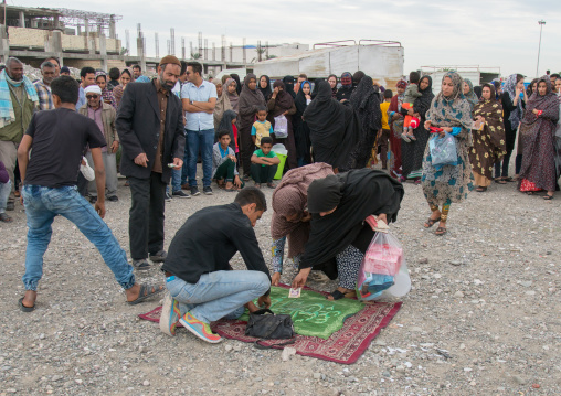 people donating money to the perfomers of a circus, Hormozgan, Minab, Iran