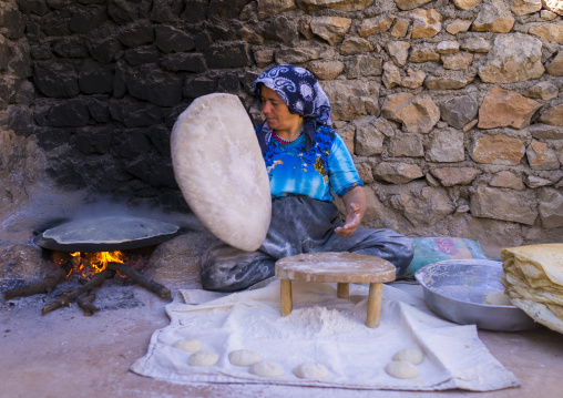 Woman Making Local Bread In The Old Kurdish Village Of Palangan At Dusk, Iran