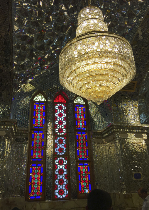 The stained glass windows and huge chandelier of the prayer hall of the shah-e-cheragh mausoleum, Fars province, Shiraz, Iran