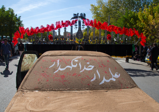 A Car Covered Of Mud In Front Of An Alam On Ashura, The Day Of The Death Of Imam Hussein, Kurdistan Province, Bijar, Iran