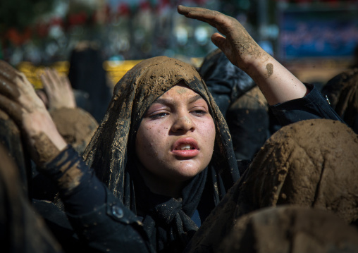 Iranian Shiite Muslim Young Woman Covered In Mud, Chanting And Self-flagellating During Ashura, The Day Of The Death Of Imam Hussein, Kurdistan Province, Bijar, Iran