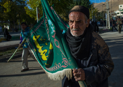 Iranian Shiite Muslim Man Covered In Mud Carrying A Flag During Ashura Day, Kurdistan Province, Bijar, Iran