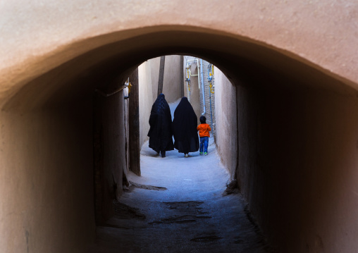 Women With A Child Walking Ina Narrow Street With Arches, Yazd Province, Yazd, Iran
