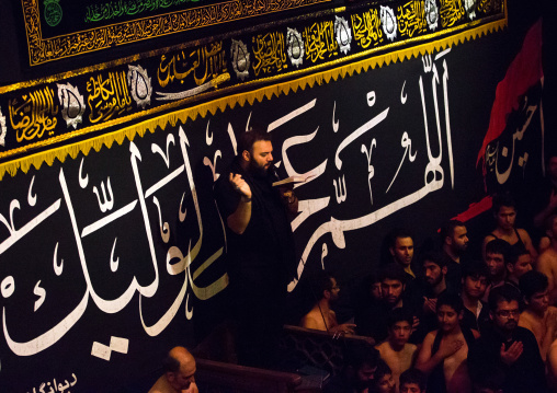 Iranian Shiite Muslim Man Leading Recitations And Songs With The Mad Of Hussein Mourners During Muharram, Isfahan Province, Kashan, Iran