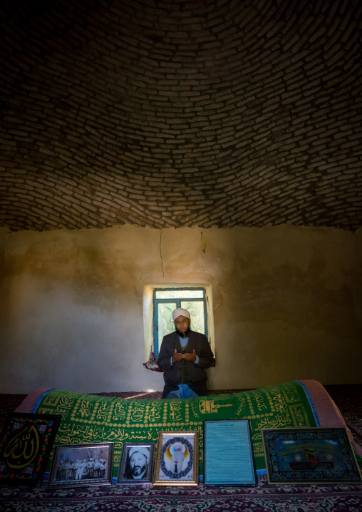 Iranian Shiite Iman Praying Inside A Shrine In Front Of A Tomb, Golestan Province, Karim Ishan, Iran