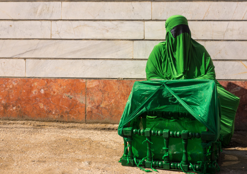 Iranian Shiite Muslim Woman On The Day Of Tasua With Her Face Covered By A Green Veil And Collecting Money In A Craddle, Lorestan Province, Khorramabad, Iran