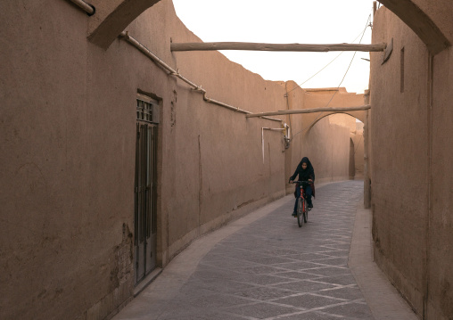Girl Riding A Bicycle In A Narrow Street, Yazd Province, Yazd, Iran