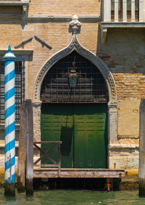 Old door on the canal, Veneto Region, Venice, Italy