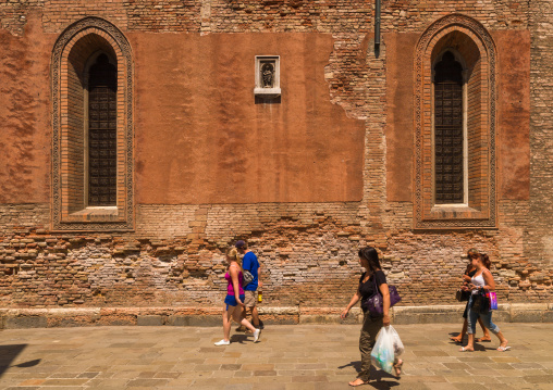 Tourists passing in front of a church, Veneto Region, Venice, Italy
