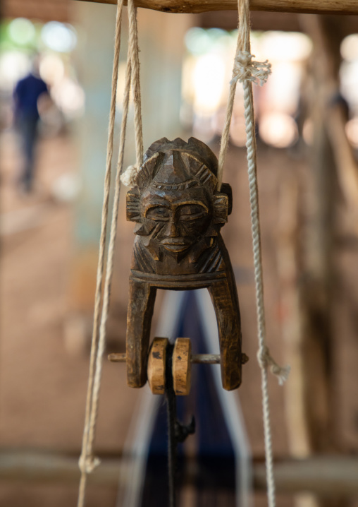 Figural heddle pulley in a traditional Senufo weaving factory, Savanes district, Waraniene, Ivory Coast