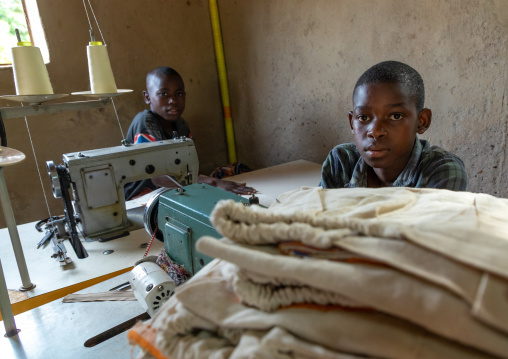 Young Senufo children working with sewing machines in a workshop, Savanes district, Waraniene, Ivory Coast
