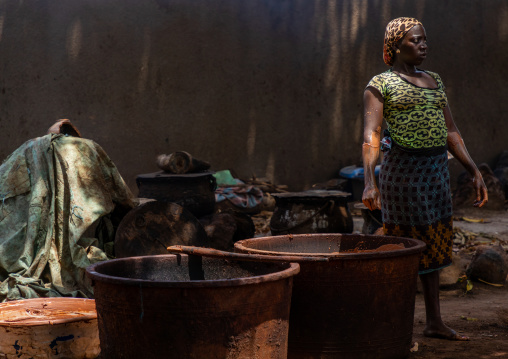 Senufo woman prepairing shea butter in a traditional karité factory, Savanes district, Tcheregnimin, Ivory Coast