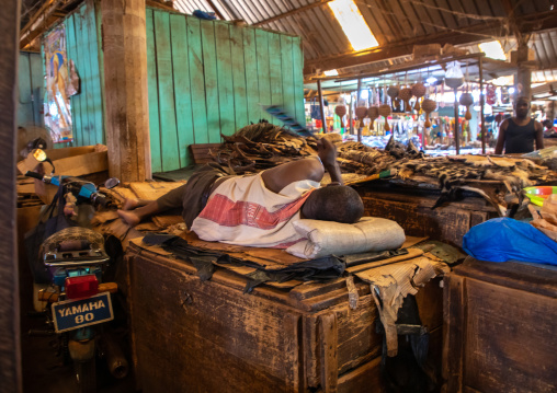 African man sleeping on a market stall during Ramadan, Poro region, Korhogo, Ivory Coast