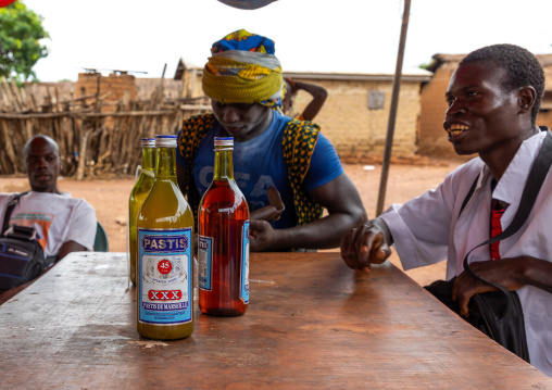 Senufo young men drinking pastis during the poro society age-grade initiation, Savanes district, Ndara, Ivory Coast