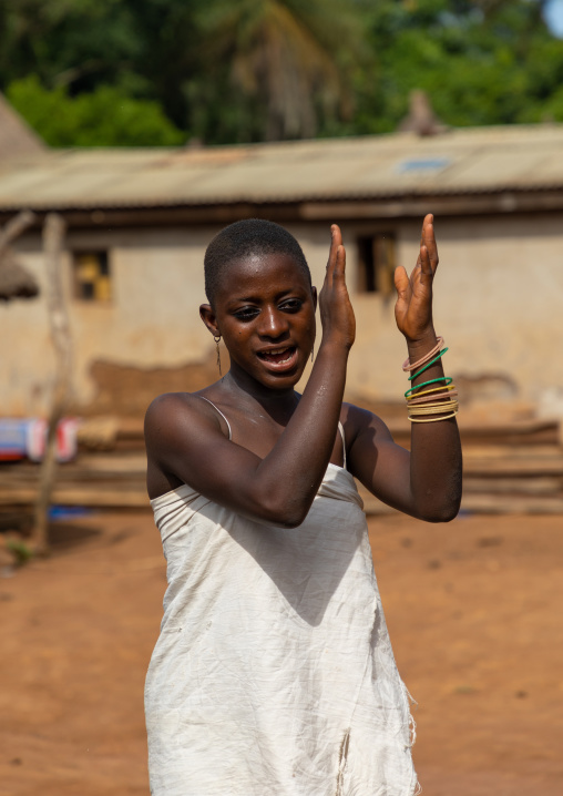 Dan tribe young woman clapping hands and dancing during a ceremony, Bafing, Gboni, Ivory Coast