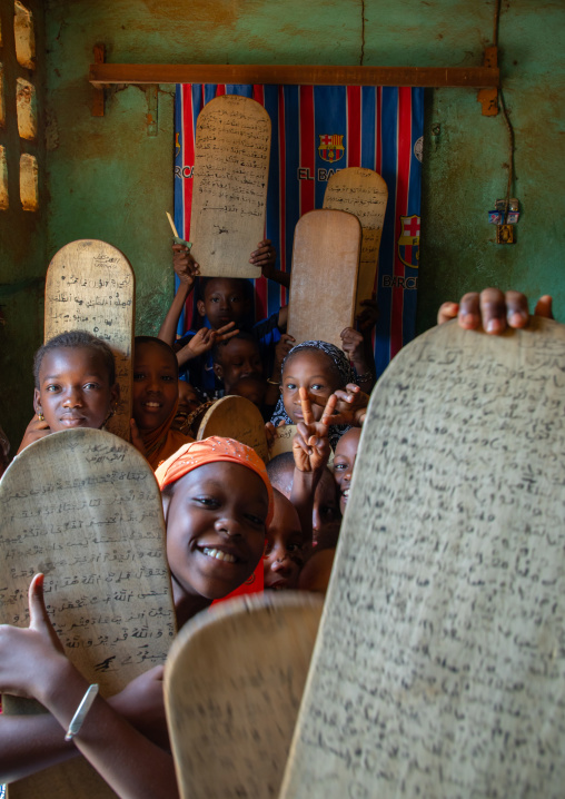 Children with wood boards for writing koran in a koranic school, Tonkpi Region, Man, Ivory Coast