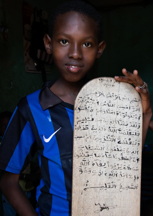 Boy with a wood board for writing koran in a coranic school, Tonkpi Region, Man, Ivory Coast