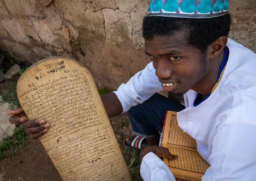 Man with a wood board for writing koran in a Koranic school, Tonkpi Region, Man, Ivory Coast