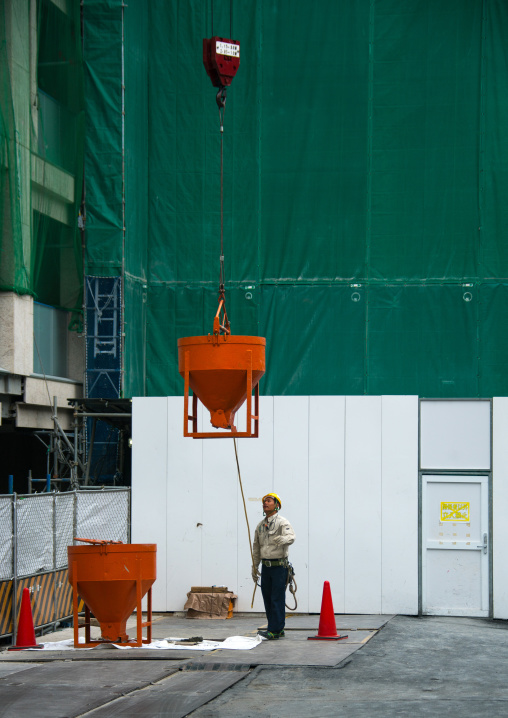 Worker in a building construction site, Kanto region, Tokyo, Japan
