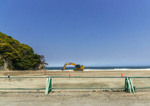 Caterpillar removing sand on a contaminated beach after the daiichi nuclear power plant irradiation, Fukushima prefecture, Tairatoyoma beach, Japan