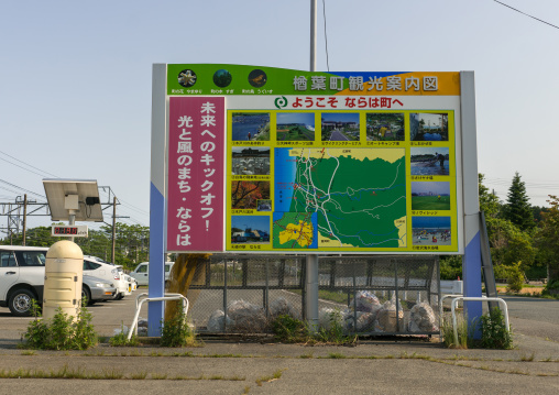 A radiation dosimeter placed in a highly contaminated area near a tourist map, Fukushima prefecture, Naraha, Japan