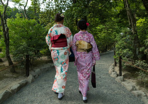 Chinese tourist women wearing geisha kimonos in a zen garden, Kansai region, Kyoto, Japan