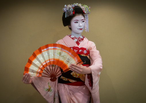 16 Years old maiko called chikasaya dancing with a fan, Kansai region, Kyoto, Japan