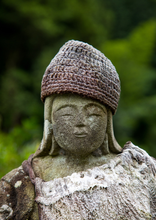 Peaceful stone religious statue with a hat, Izu peninsula, Izu, Japan