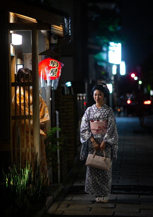 Portrait of a maiko called Chikasaya in front of her okiya, Kansai region, Kyoto, Japan