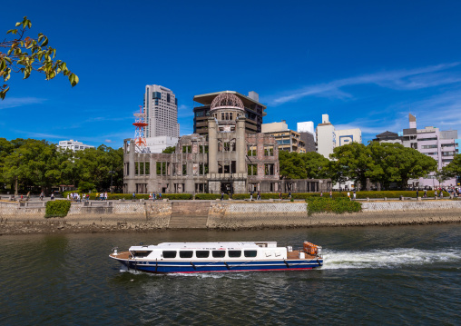 Ferry boat in ota river in front of the Genbaku dome in Hiroshima peace memorial park, Chugoku region, Hiroshima, Japan