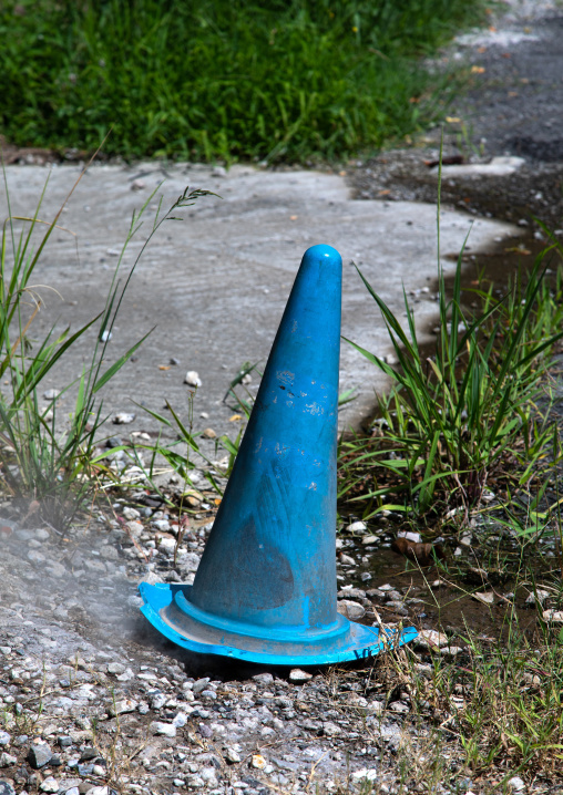 Traffic cone to protect a hot spring in the street, Oita Prefecture, Beppu, Japan