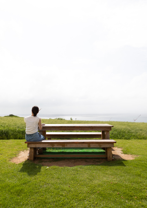 Lonely woman sit on a bench, Yaeyama Islands, Ishigaki-jima, Japan