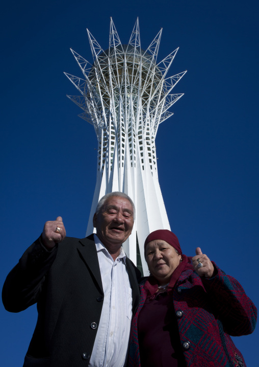 Couple Of Ethnic Kazakh Tourists Under The Baiterek Tower Astana, Kazakhstan
