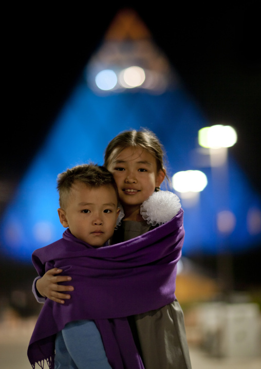Cold Evening For Two Kids In Front Of The Peace Pyramid, Astana, Kazakhstan