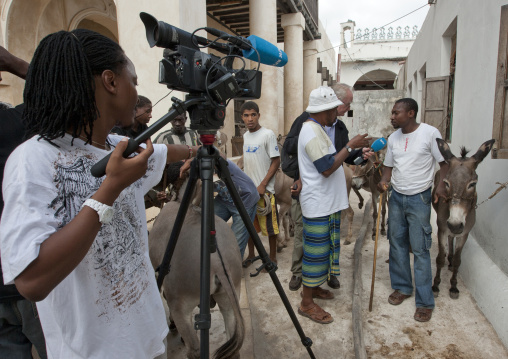 Reporter interviewing an inhabitant during Maulid festival, Lamu County, Lamu, Kenya