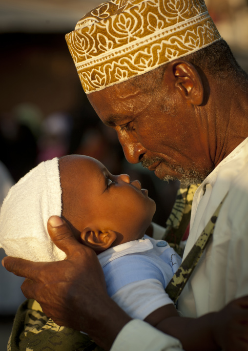 Muslim father with his baby, Lamu County, Lamu, Kenya