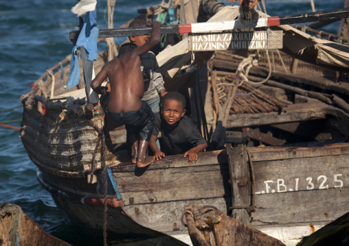 Two young boys playing at the poop deck of a dhow, Lamu County, Lamu, Kenya