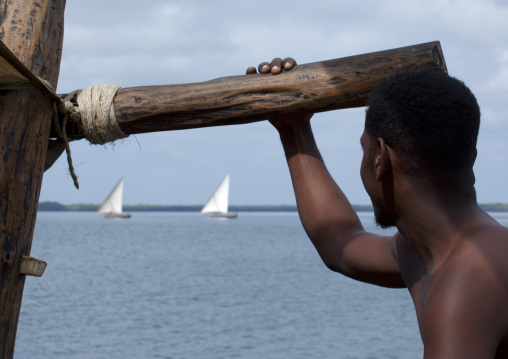 Kenyan man on a dhow sailing, Lamu County, Lamu, Kenya