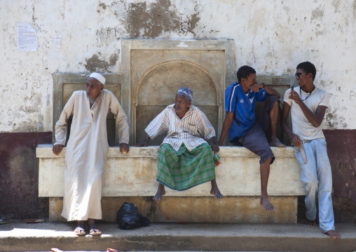 Group of people sitting on a fountain, Lamu county, Lamu, Kenya