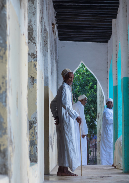 Old muslim men standing at the entrance of a mosque, Lamu county, Lamu town, Kenya