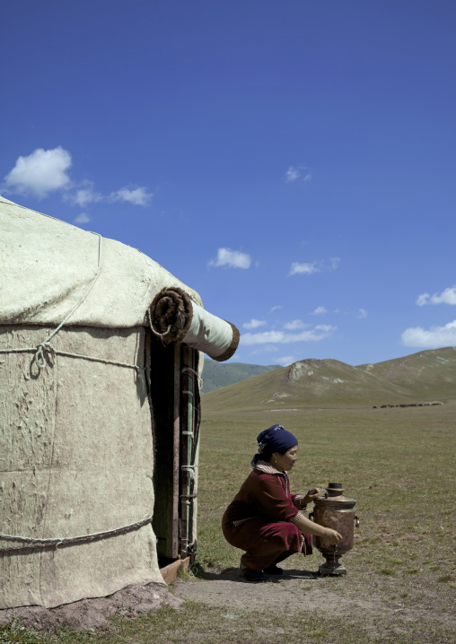 Woman Opening The Tap Of A Water Jug In Front Of Her Yurt, Jaman Echki Jailoo Village, Song Kol Lake Area, Kyrgyzstan