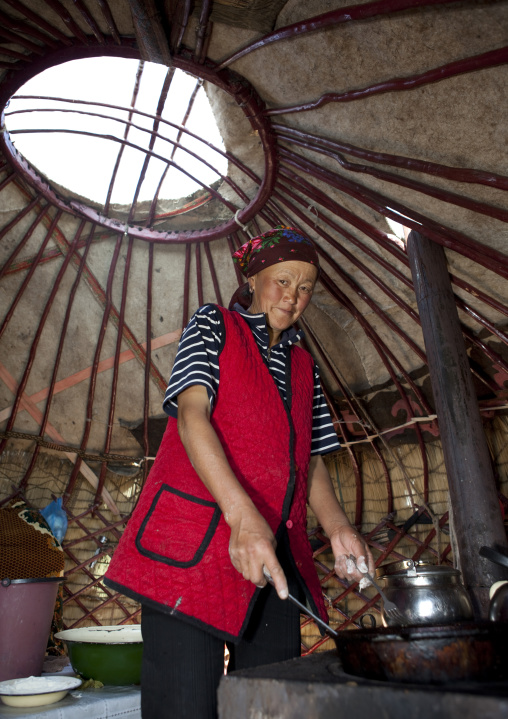 Woman With Headscarf Cooking Inside Her Yurt, Song Kol Lake Area, Kyrgyzstan