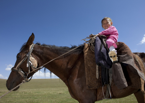 Young Girl Riding A Horse, Song Kol Lake Area, Kyrgyzstan