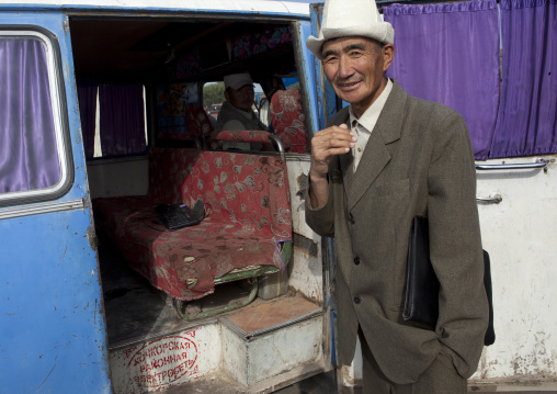 Old Man With Kalpak Hat Getting In A Minibus, Kochkor Animal Market, Kyrgyzstan