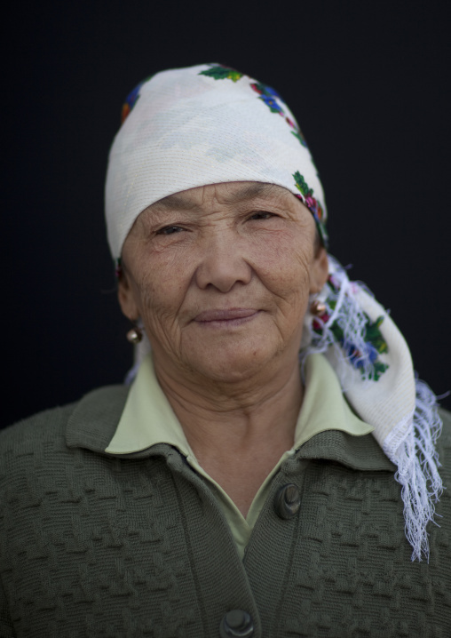 Old Woman Wearing A Headscarf At The Animal Market Of Kochkor, Kyrgyzstan