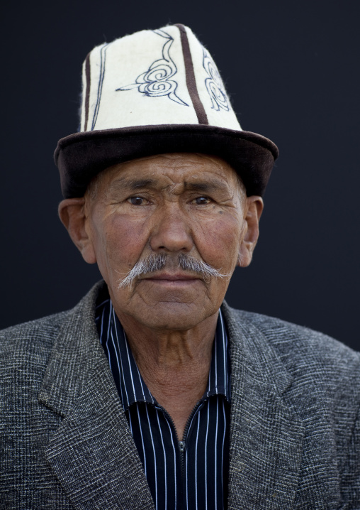 Old Man Wearing A Kalpak Hat At The Animal Market Of Kochkor, Kyrgyzstan