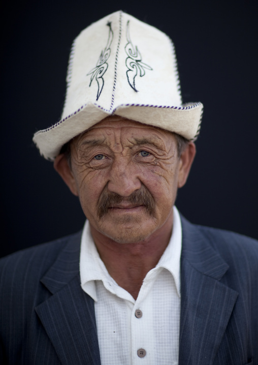 Old Man Wearing A Kalpak Hat At The Animal Market Of Kochkor, Kyrgyzstan