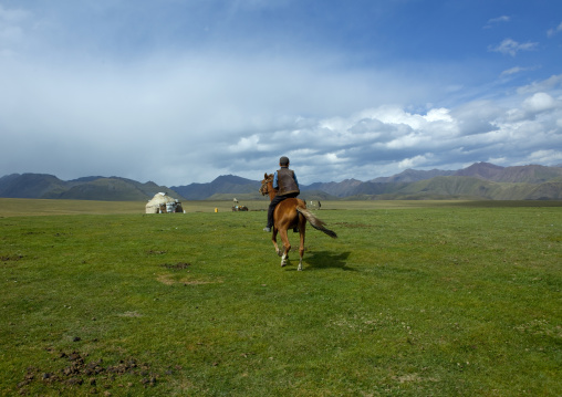 Boy Riding A Horse In The Steppe, Saralasaz Jailoo, Kyrgyzstan