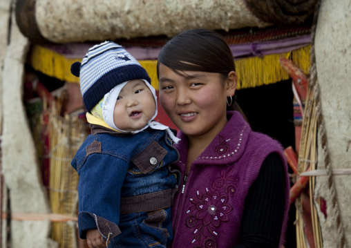 Woman Holding Her Baby In Front Of Her Yurt, Saralasaz Jailoo, Kyrgyzstan