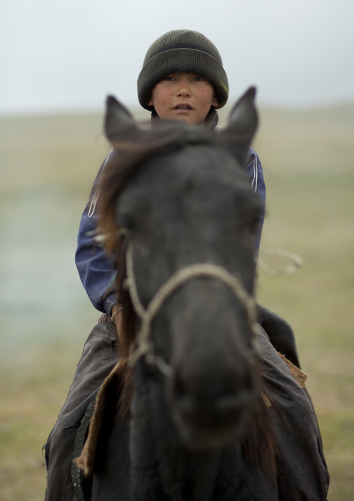 Boy With Wooly Riding A Horse, Saralasaz Jailoo, Kyrgyzstan